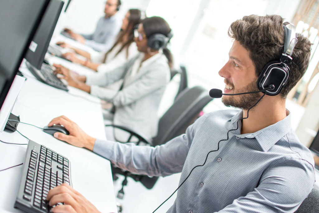 Smiling,Handsome,Male,Customer,Support,Phone,Operator,With,Headset,Working